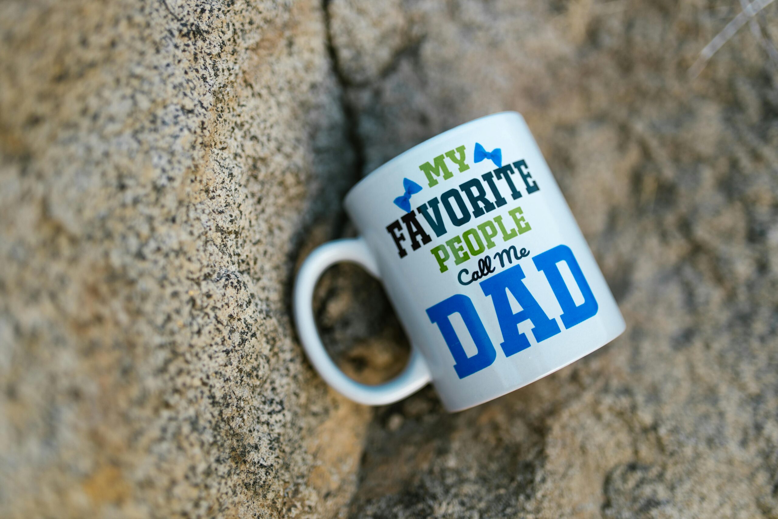 Home Ceramic mug with 'My Favorite People Call Me Dad' design on a stone background.